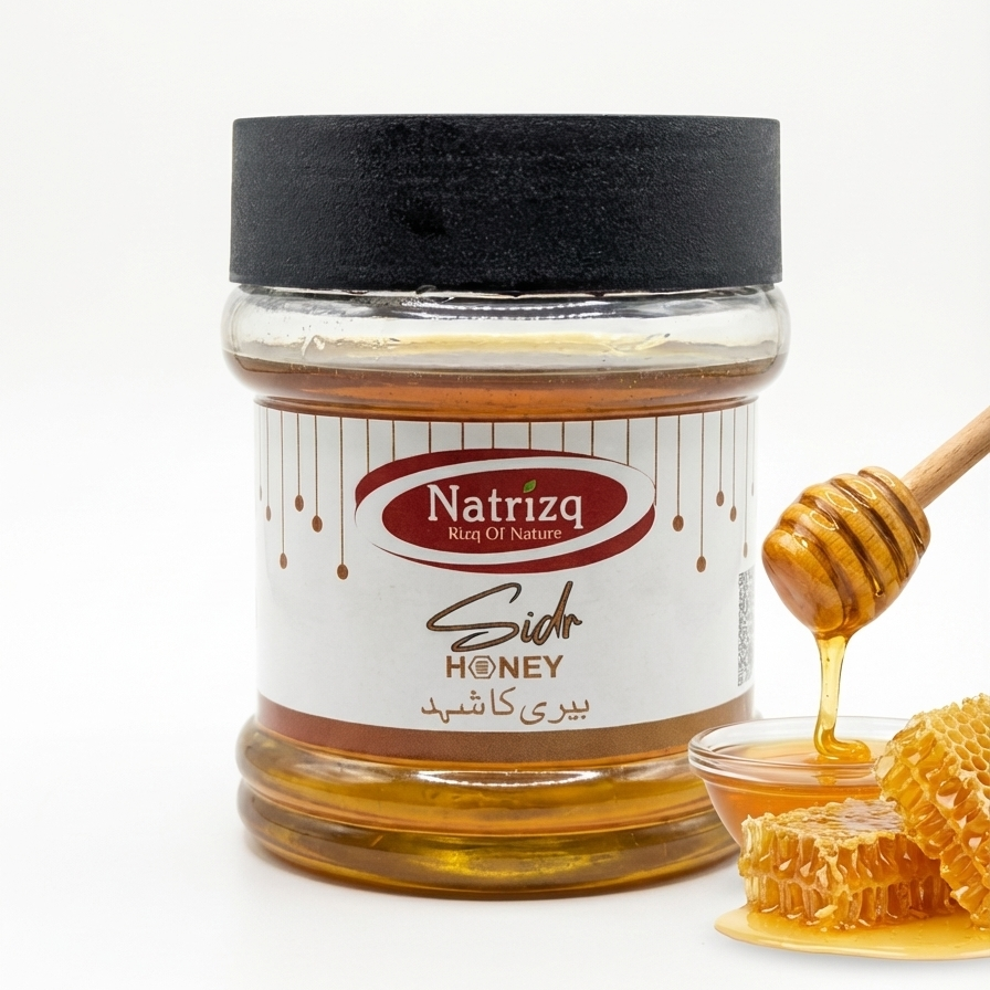 Jar of Natrizq Sidr Honey with honeycomb and dipper on a white background